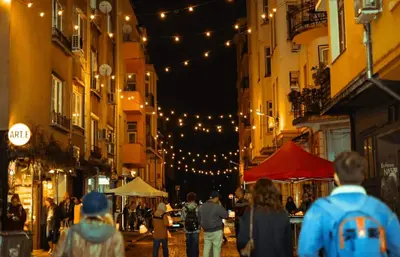 a group of people walking down a street at night at 2BR Apt - Parking - Central - 1st floor - ACs in Sofia