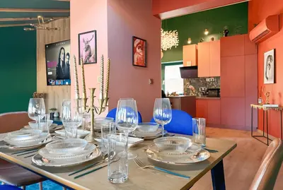 a dining room table with plates and glasses on it at Central 2BR with Designer Interior and Work Desk in Sofia