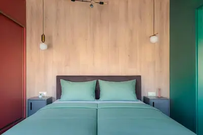 a bed with blue pillows in a room at Central 2BR with Designer Interior and Work Desk in Sofia