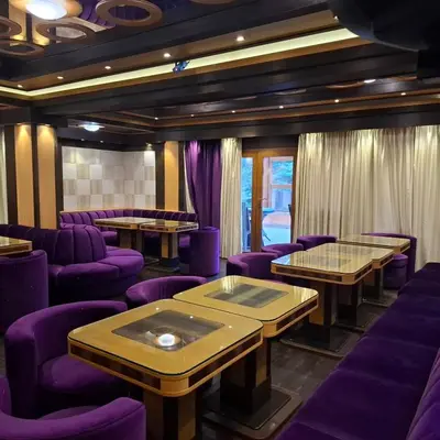 a restaurant with purple tables and purple chairs at Green Hotel Fortuna in Sapareva Banya