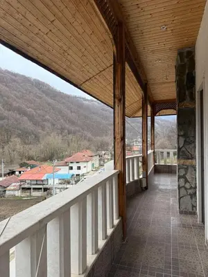 a balcony of a house with a view of a mountain at Къща за гости GREEN HILLS in Beli Osŭm
