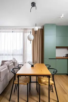 a dining room with a table and a couch at Spacious 2BR Apartment - Modern Design in Sofia