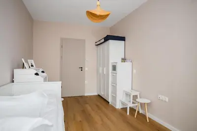 a bedroom with a bed and a table and a stool at Spacious 2BR Apartment - Modern Design in Sofia