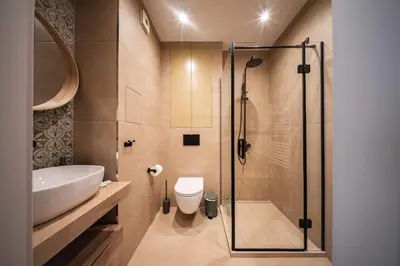 a bathroom with a shower and a toilet and a sink at Spacious 2BR Apartment - Modern Design in Sofia