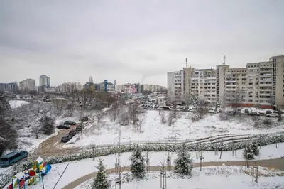 a city in the snow with buildings and cars at Spacious 2BR Apartment - Modern Design in Sofia