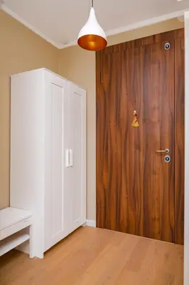 a room with a white door and a wooden closet at Sunny 1BR with Balcony in Sofia