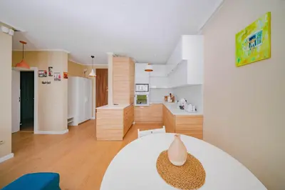 a kitchen and living room with a table in a room at Sunny 1BR with Balcony in Sofia