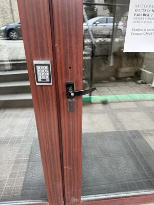 a wooden door with a lock on a street at Borealis Apartment in Bansko