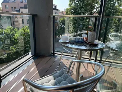 a balcony with a table and two chairs and a table with a table at 5 minutes sity center plus parking in Plovdiv