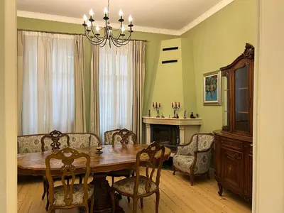 a dining room with a table and chairs and a fireplace at Belview Apartment with Panoramic Old Town View in Plovdiv