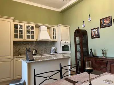 a kitchen with white cabinets and a counter top at Belview Apartment with Panoramic Old Town View in Plovdiv