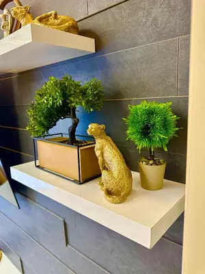 a shelf with two potted plants and a bear on it at Regatta Park 1BR Exclusive Suite Parking Included in Plovdiv