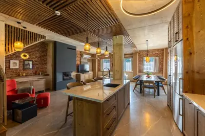 a kitchen and living room with a table and chairs at Luxurious, modern house in the nature in Belchin in Belchin