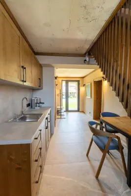 a kitchen with a sink and a table with chairs at Luxurious, modern house in the nature in Belchin in Belchin