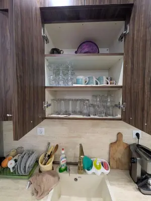 a kitchen counter with a sink in a kitchen at Наслада in Panagyurishte
