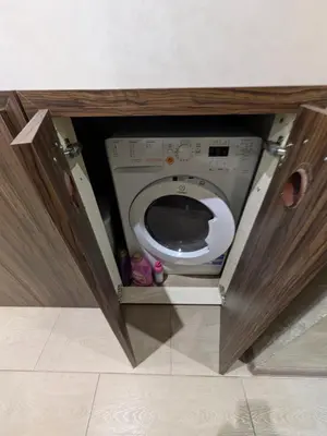 a small bathroom with a toilet in a cabinet at Наслада in Panagyurishte