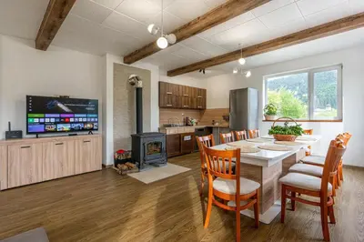 a kitchen and dining room with a table and chairs at Вила Звездопад in Manastir