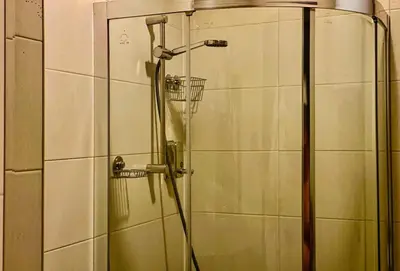a shower with a glass door in a bathroom at Studio with pool, SPA near the Ski Lift in Bansko