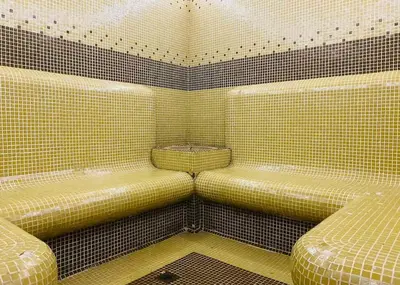 a room with two seats in a tiled room at Studio with pool, SPA near the Ski Lift in Bansko