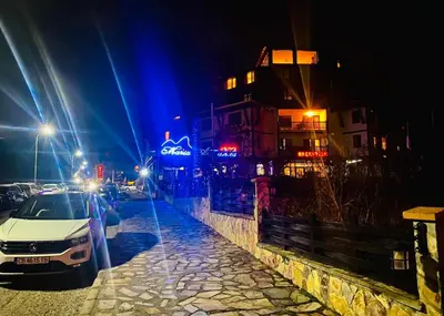 a car parked on the side of a street at night at Studio with pool, SPA near the Ski Lift in Bansko