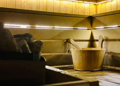 a copper pot and wooden utensils on a stove at Studio with pool, SPA near the Ski Lift in Bansko