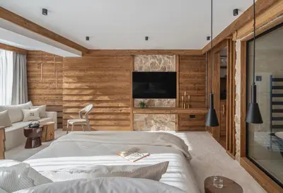 a bedroom with a large bed and a tv at Flora Boutique Hotel in Borovets