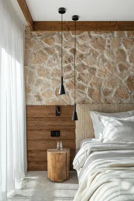 a bedroom with a bed and a stone wall at Flora Boutique Hotel in Borovets