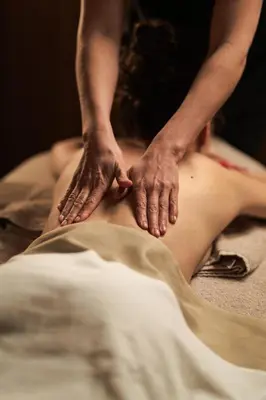 a woman getting a massage on her back with her hands at Flora Boutique Hotel in Borovets