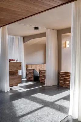 a bedroom with white drapes on the walls at Flora Boutique Hotel in Borovets