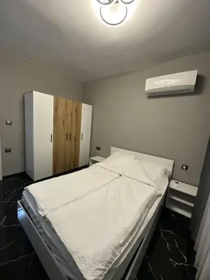 a bedroom with a white bed and a refrigerator at Diamond Casa with Free Private Parking in Plovdiv