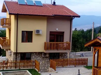 a house with a red roof and a balcony at Mini Complex Rilski Terasi in Sapareva Banya