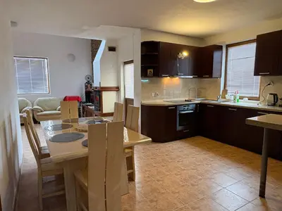 a kitchen with a table and a dining room at Mountain Family Guest House Rayovo in Rayovo