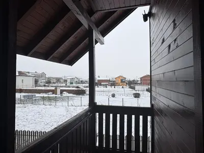 an outside view of a snowy field from a building at Mountain Family Guest House Rayovo in Rayovo