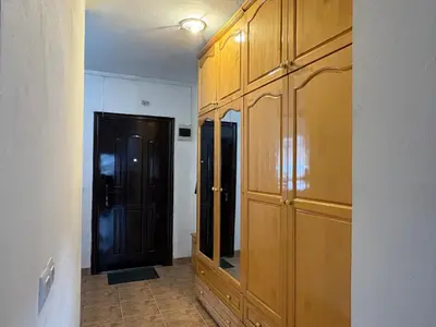 a room with a large wooden cabinet with a mirror at Mountain Family Guest House Rayovo in Rayovo