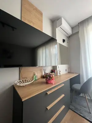 a kitchen with a counter with a chair and a mirror at 2-Bedroom Luxury Apartment in the center of Sofia in Sofia