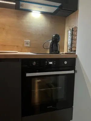 a black stove in a kitchen with a tea kettle on it at 2-Bedroom Luxury Apartment in the center of Sofia in Sofia