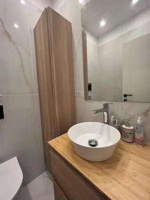 a bathroom with a white sink and a mirror at 2-Bedroom Luxury Apartment in the center of Sofia in Sofia