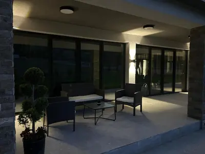 a patio with two chairs and a table on a building at Резиденция БАЛМОРА in Kalofer