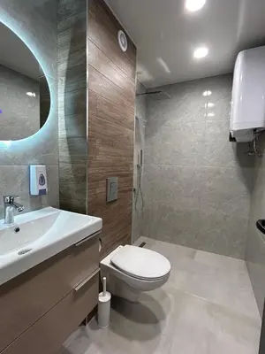 a bathroom with a toilet and a sink at Резиденция БАЛМОРА in Kalofer