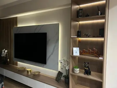 a living room with a television on a wall at Резиденция БАЛМОРА in Kalofer