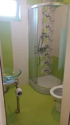 a bathroom with a shower and a sink and a toilet at Кичук Париж in Plovdiv