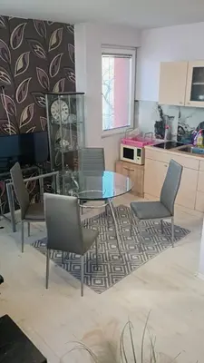 a kitchen with a glass table and chairs at Кичук Париж in Plovdiv