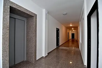 an empty hallway with a door in a building at Velingrad Prime 2-Bedroom Apartment in Velingrad