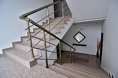 a staircase in a house with a metal railing at Velingrad Prime 2-Bedroom Apartment in Velingrad