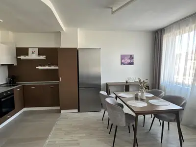 a kitchen and dining room with a table and chairs at Velingrad Prime 2-Bedroom Apartment in Velingrad