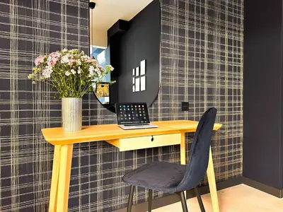 a desk with a laptop and a vase of flowers at Duplex Retreat 2 Studios Balconies, Wi-Fi in Sofia