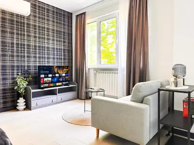 a living room with a couch and a tv at Duplex Retreat 2 Studios Balconies, Wi-Fi in Sofia