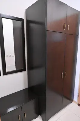 a black cabinet and a mirror in a room at The Mountain Hug Studio 1 by SI Stay in Bansko
