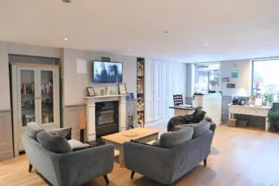 a living room with two couches and a table at The Mountain Hug Studio 1 by SI Stay in Bansko