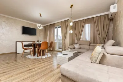 a living room with a couch and a table at Sunny Modern 1BR Retreat with Cozy Balcony in Plovdiv